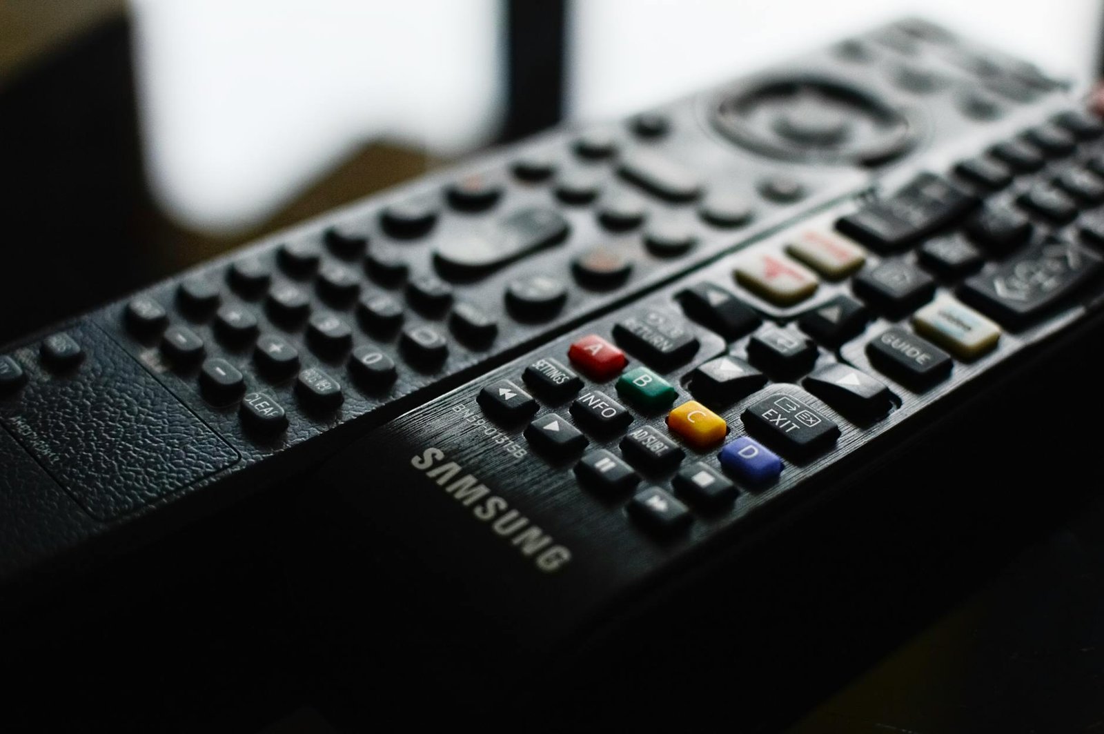 Best IPTV App for Samsung TV — Detailed close-up of a Samsung remote control showing buttons and layout | OTT-TV