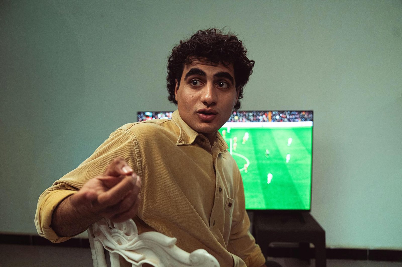 Best IPTV for Sports — Person watching a live soccer match broadcast on a TV | OTT-TV