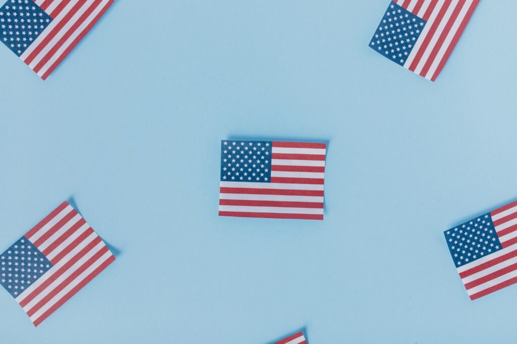 Best IPTV USA in 2026 — Multiple American flags arranged on a pastel blue background | OTT-TV